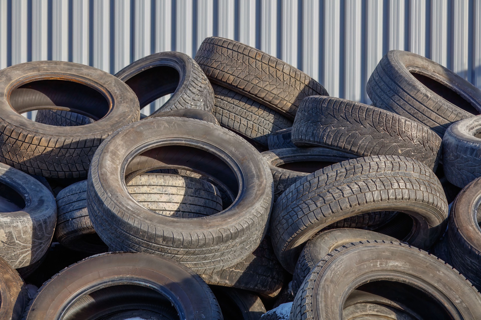 Pile of Used Car Tires in Outdoor Storage