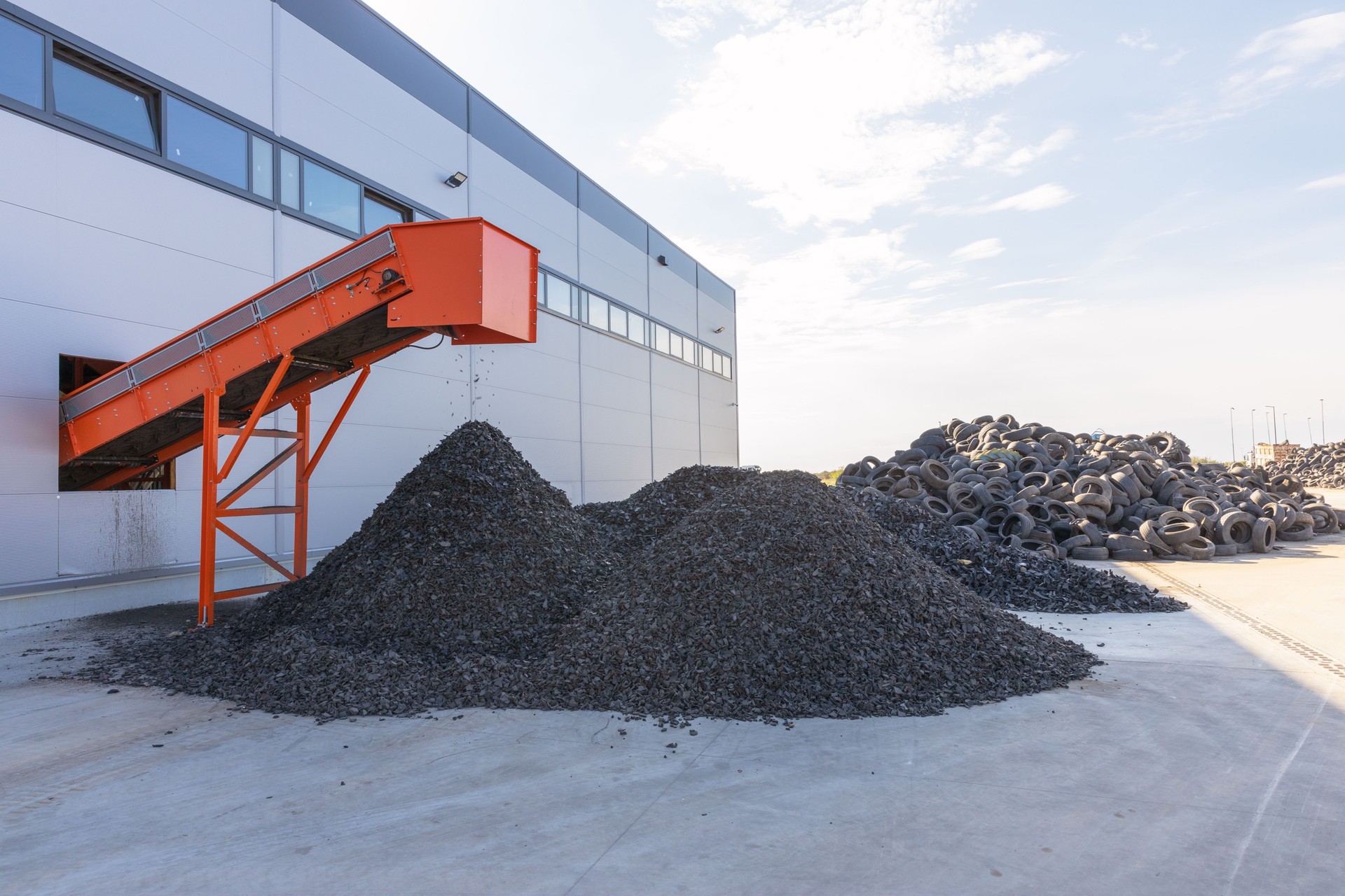 Tire Recycling. Conveyor Belt Transporting Shredded Rubber From Recycling Facility To Storage Piles.